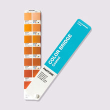 Load image into Gallery viewer, The Pantone Color Bridge Coated GG6103C colour guide fan deck shown open against a light grey background, displaying multiple warm colour chips and a bright turquoise cover card.