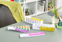 Load image into Gallery viewer, Pantone solid guide set gp1605c on a desk